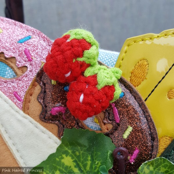 crochet strawberry detail on picnic themed handbag