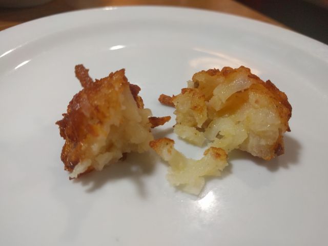 Cross-section of a Denny's Bacon Cheddar Tot.