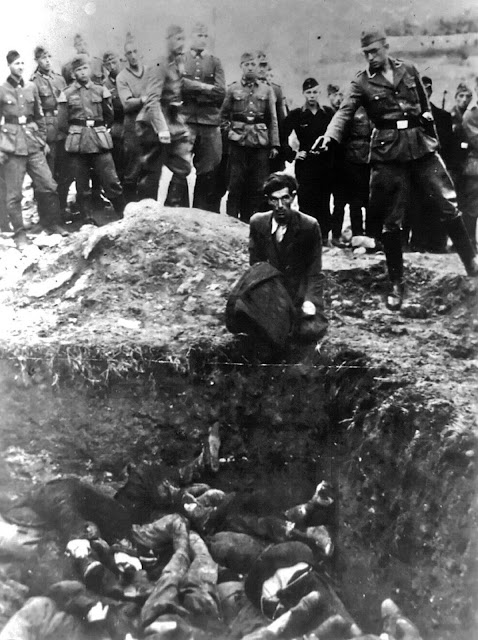 This photo provided by Paris' Holocaust Memorial shows a German soldier shooting a Ukrainian Jew during a mass execution in Vinnytsia, Ukraine, sometime between 1941 and 1943. This image is titled 