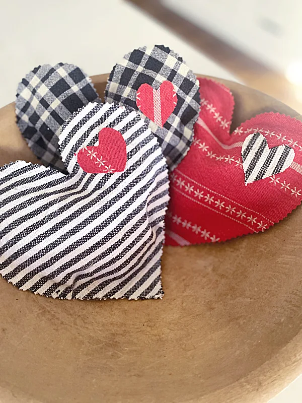 embellished hearts in wooden bowl