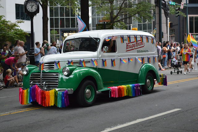 An old car from the 1920's (or so) decked out in pride gear