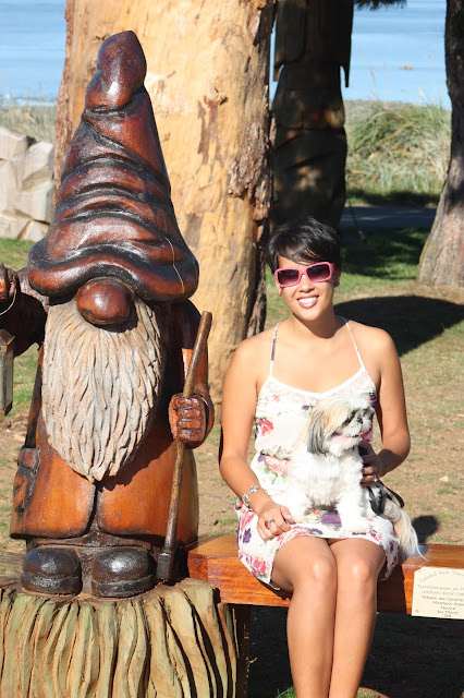 Kristina and dog with gnome on a bench