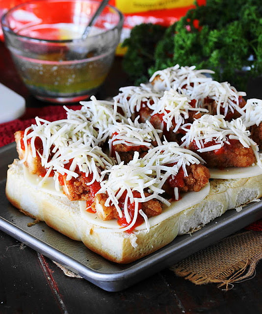 Making Chicken Parmesan Sliders - Chicken Tender Pieces Topped with Mozzarella Image