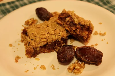Date walnut bars on a serving plate.