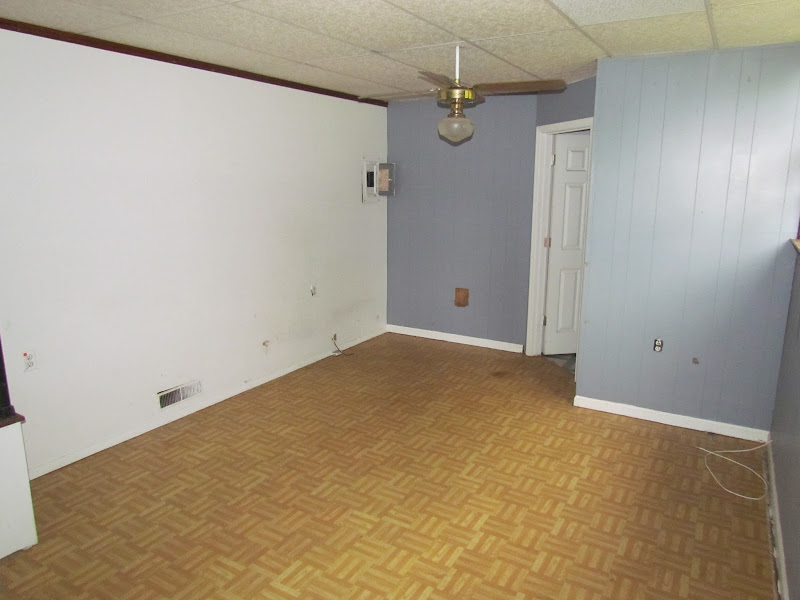 Notice the drop ceiling & the linoleum floor that looks like wood  title=