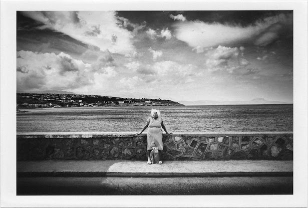 dirty photos - et - a black and white photo of old woman by the sea in rethymno