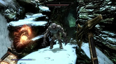 A screenshot in the first person, with a sword in one hand and a fireball in the other, about to attack a troll.