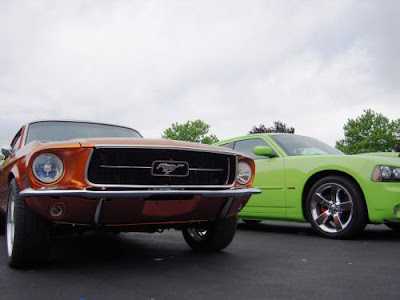 Some cool autos vintage Ford Mustang next to a Dodge Charger