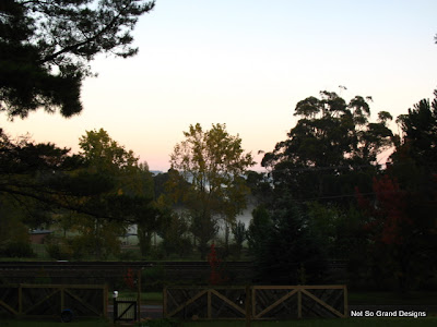  The view from our front windows across the town sports oval and park on a crisp autumn morning - trees turning crimson and mist rising into the clear cold air.