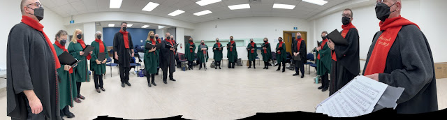 Panorama of the Stairwell Carollers in the "green room" before the concert