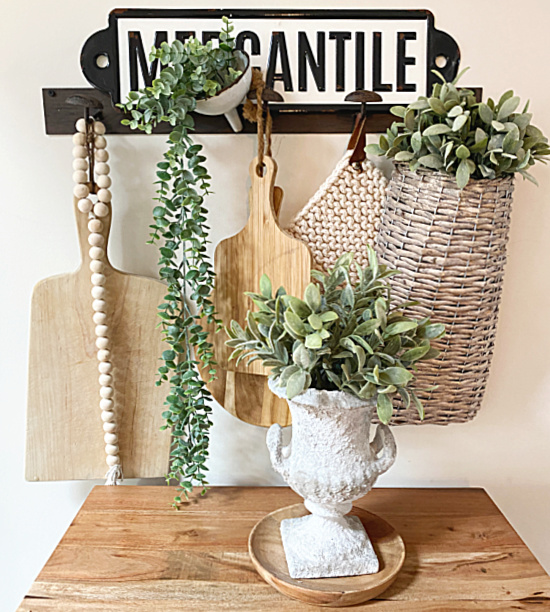 cement urn and hooks with baskets and cutting boards