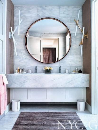 elegant modern powder room with white marble wall sink and round mirror
