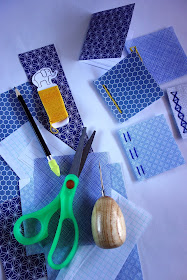 scissors, thread, pencil, awl, paper, craft materials, security envelopes, sewing, bookbinding
