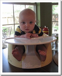 Reid in his Bumbo seat watching us eat lunch, 7-9-09