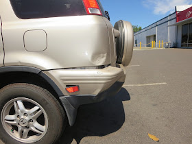 Dented quarter panel and bumper on Honda CR-V at Almost Everything Auto Body