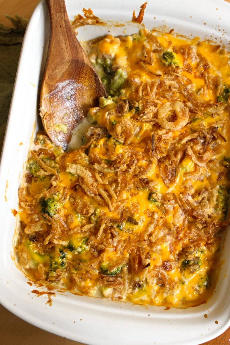 This Broccoli Cheddar Casserole is made with tender broccoli, a creamy cheddar cheese sauce, and french fried onions. It will be the hit of your next holiday dinner! #sidedishrecipes #broccoli #broccolicasserole