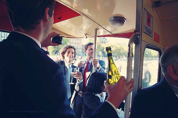 guests having fun and drinking on a red routemaster wedding bus