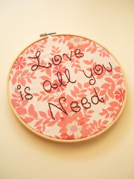 hand embroidered hoop featuring The Beatles love is all you need song lyrics on vintage fabric