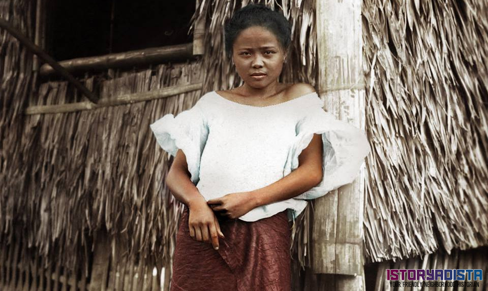 Filipino girl posing at a nipa hut (c1910)