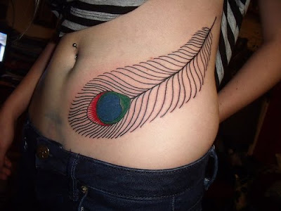 cross tattoos for girls on side. peacock feather tattoo girls