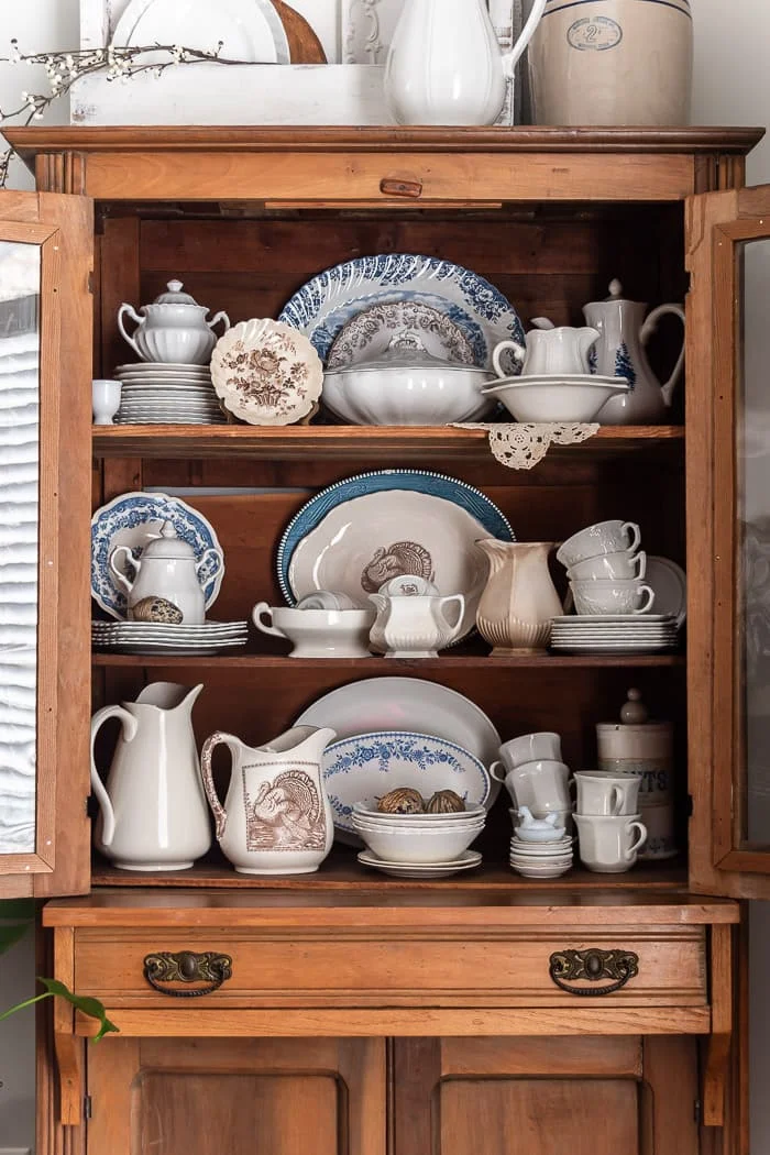 white ironstone, brown transferware, blue transfer in primitive pine hutch