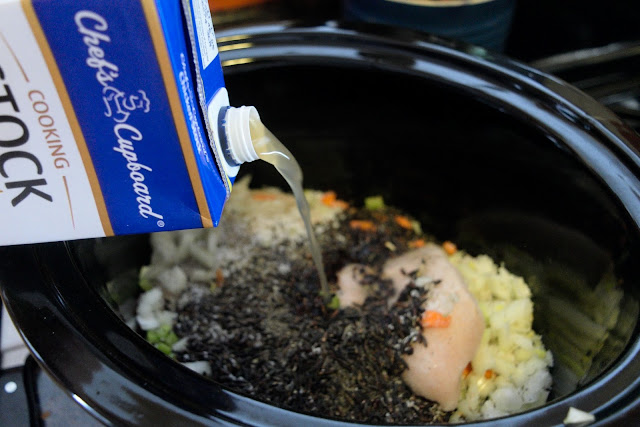 Chicken stock being added to the crock pot.