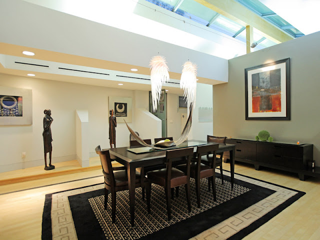 Photo of another dining room with wooden black table and black chairs