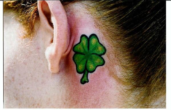 This picture shows the green four leaf clover tattoo with
