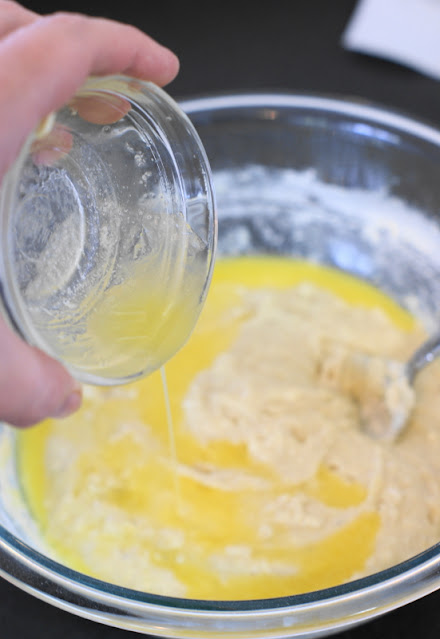 Pouring Melted Butter into Cornbread Batter Image