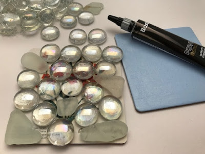 Sea glass and glass pebbles glued to a coaster