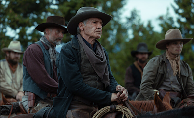 Five cowboys all on horseback looking intently at someone. The one in the front and focus is Harrison Ford looking exceptionally grizzled.