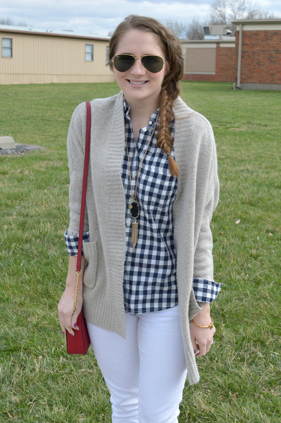 navy gingham top with a beige sweater and white jeans