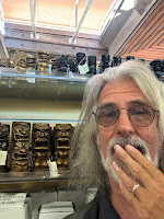 Man who is shocked (shocked, I tell you) by tiny plastic tourist ki'i figurines.