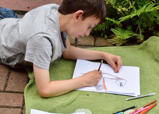 Boy colouring and drawing