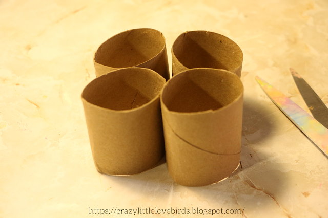 Four cut sections of paper towel rolls