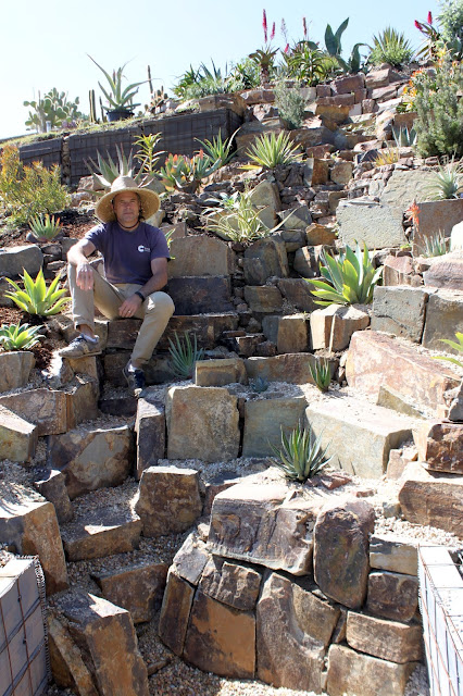 A gardener sitting in his landscape