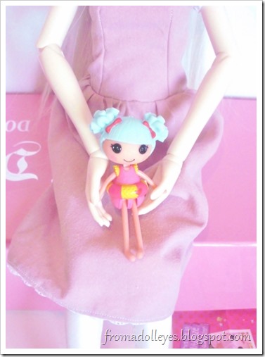 A Lalaloopsy blind bag doll being held by a msd sized ball jointed doll to compare the size.  The Lalaloopsy doll is dressed for the beach.