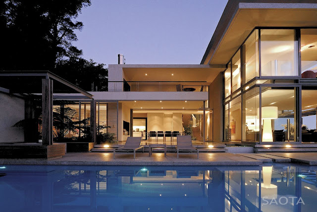 Picture of swimming pool by the house at sunset