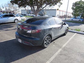 Mazda 3 with peeling Plasti Dip before repainting at Almost Everything Auto Body