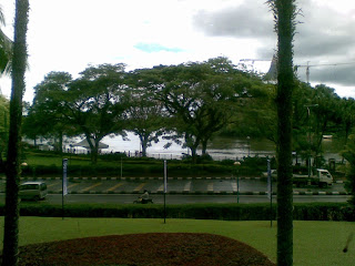 view of the Kuching Waterfront with shady trees and Sg. Sarawak (Sarawak River) from the Hilton one rainy day