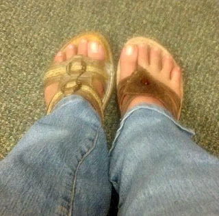 Wearing mismatched sandals.