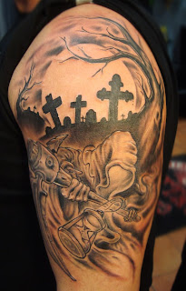 Death tattoo covering the shoulder and the arm: Death in a graveyard