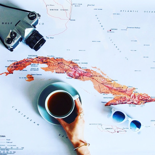 Coffee and sunglasses on a map 