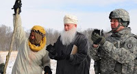 Army Col. Brian Copes, far right, congratulates a role player representing an Afghan leader during a mock groundbreaking ceremony on a snowy day at the Muscatatuck Urban Training Center at Camp Atterbury, Ind.