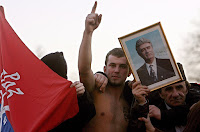 A student holds an Obraz flag and a portrait of Radovan Karadžić in a Time Magazine photo.