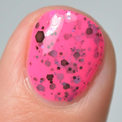 neon pink nail polish with glitter swatch