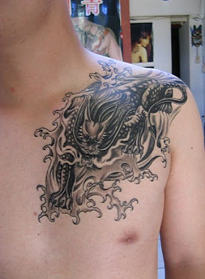 a dragon tattoo design on the shoulder