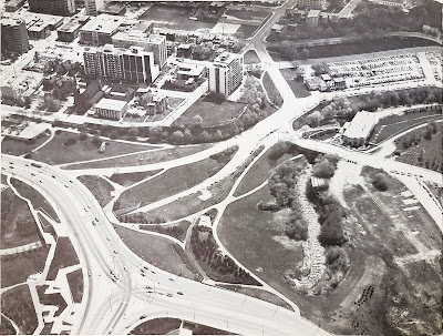 Aerial photo from above the Portage Bridge intersection with Wellington looking south toward Christ Church Cathedral Hill and Wellington Street through LeBreton Flats, as far as Brickhill.