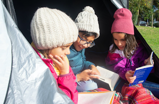 Kids reading outside