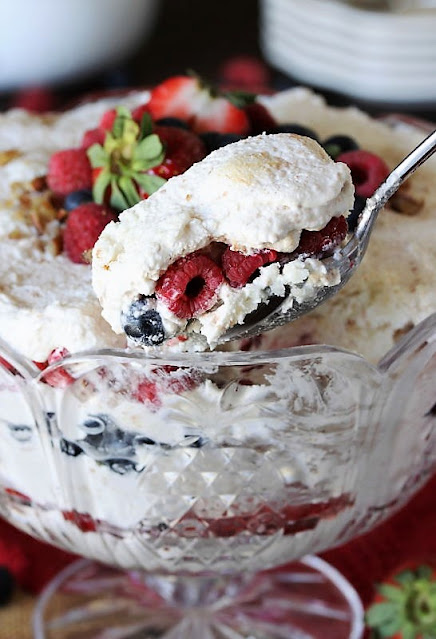 Serving Spoon of Triple Berry Punch Bowl Cake Image